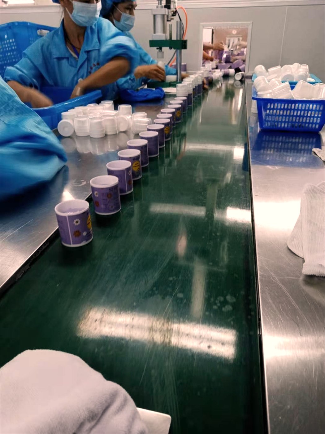 Cream jars moving along the packing line